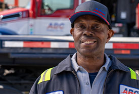 ABC employee smiling in front of an ABC Supply truck