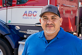ABC employee standing in front of an ABC Supply truck