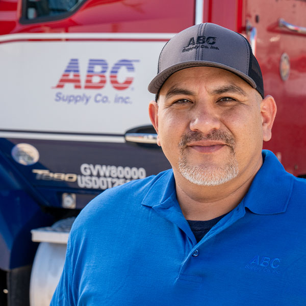 ABC employee standing in front of an ABC Supply truck