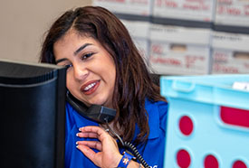 ABC office employee talking on a phone